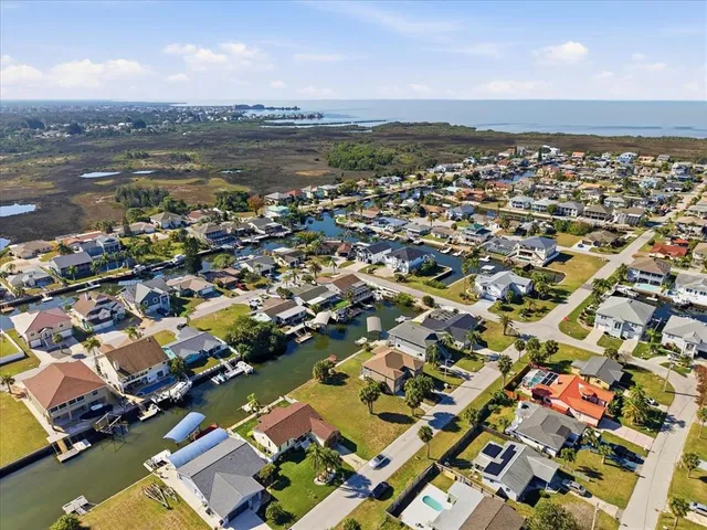 an aerial view of a city with lots of residential buildings and lake view