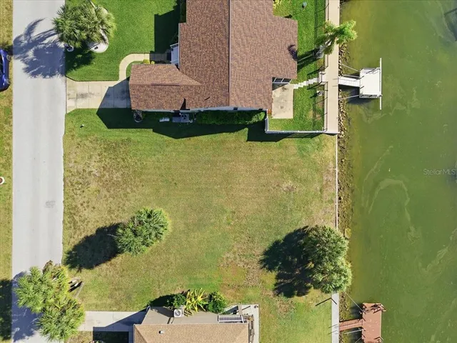 an aerial view of a house with a yard