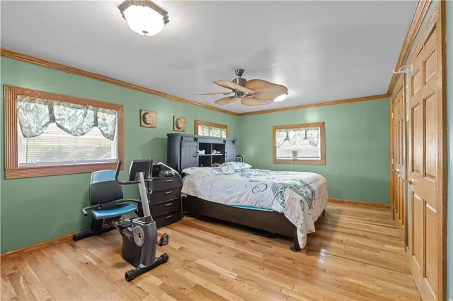 a bedroom with a bed and windows