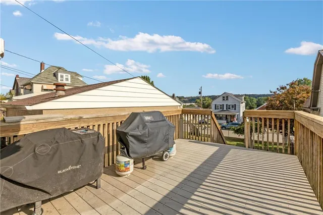 a roof deck with table and chairs