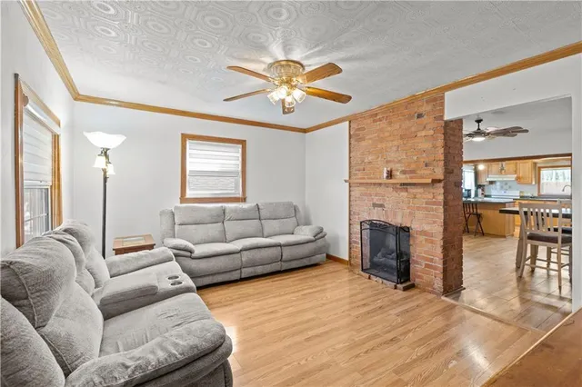 a living room with furniture a fireplace and a chandelier