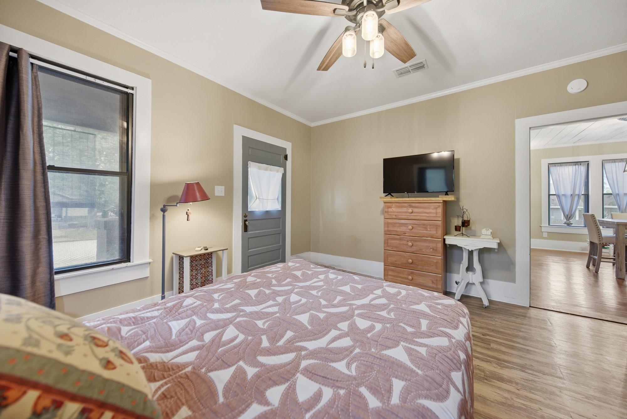 1501 South Austin Street Brenham, TX 77833 - Photo 14 of 36 a bedroom with a bed and a chandelier