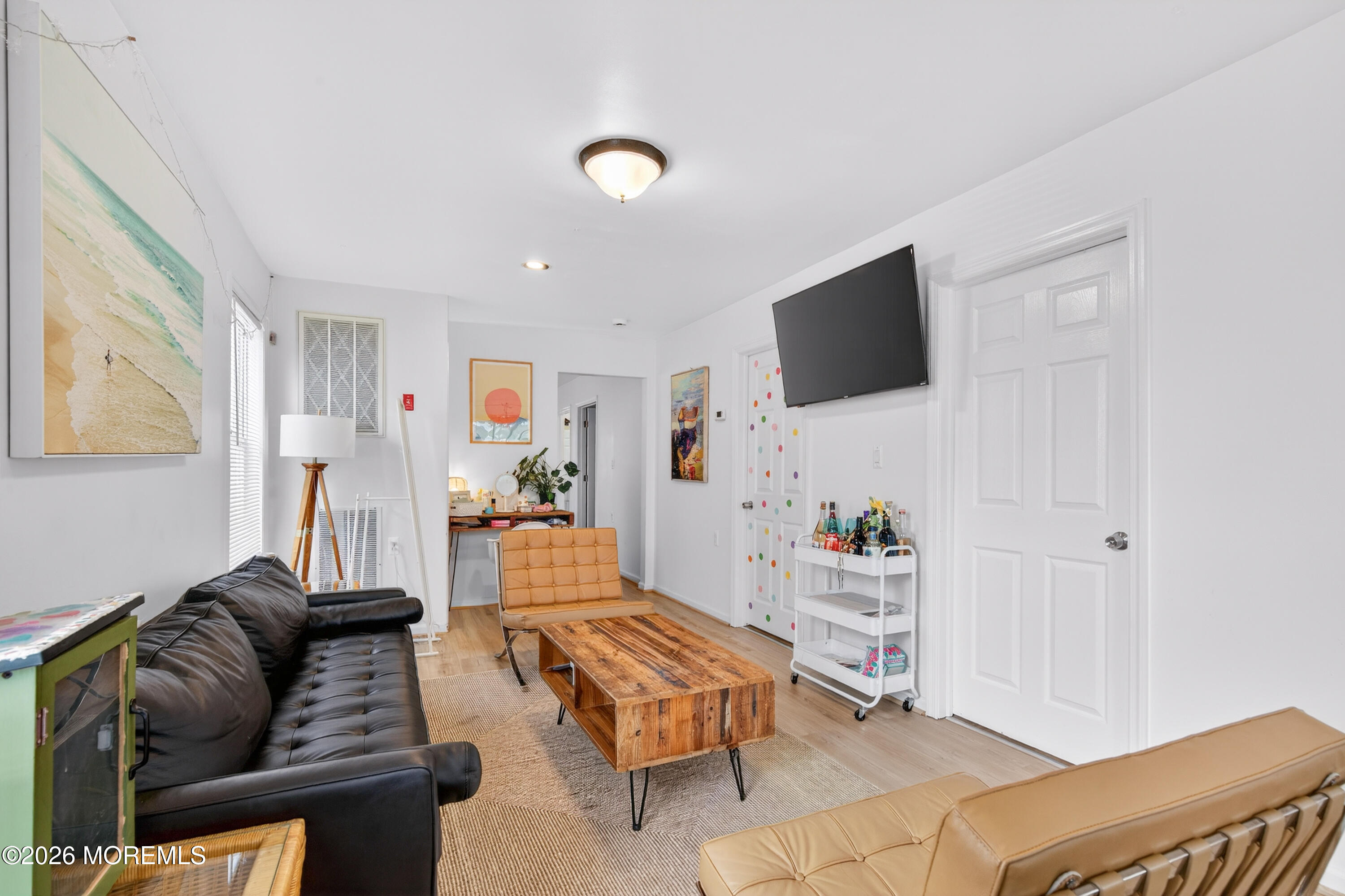191 3rd Avenue, Unit 1 Manasquan, NJ 08736 - Photo 4 of 8 a living room with furniture and a flat screen tv