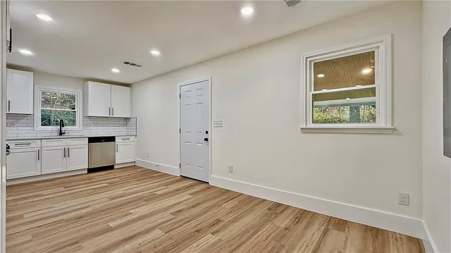 a view of kitchen with wooden floor electronic appliances and window
