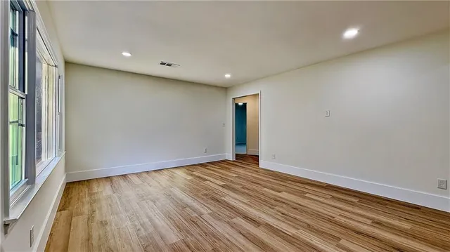 a view of room with window and wooden floor