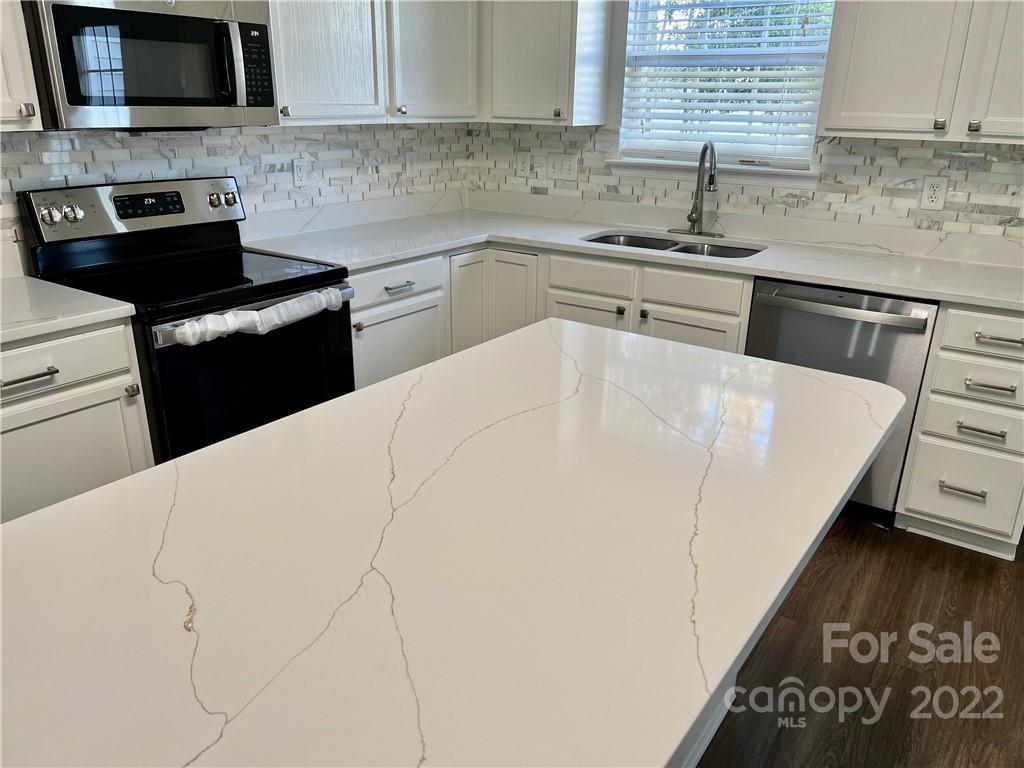 841 Dillard Road Rock Hill, SC 29730 - Photo 8 of 20 a kitchen with a sink a stove and cabinets