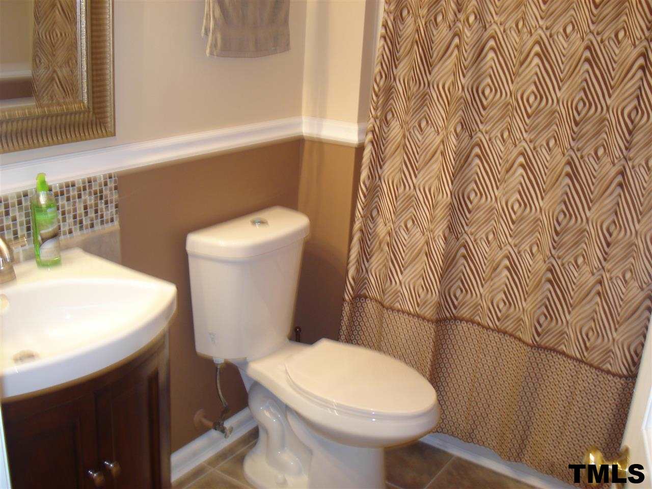 3755 Old Stage Road North Angier, NC 27501 - Photo 12 of 15 a white toilet sitting next to a white sink and a shower curtain
