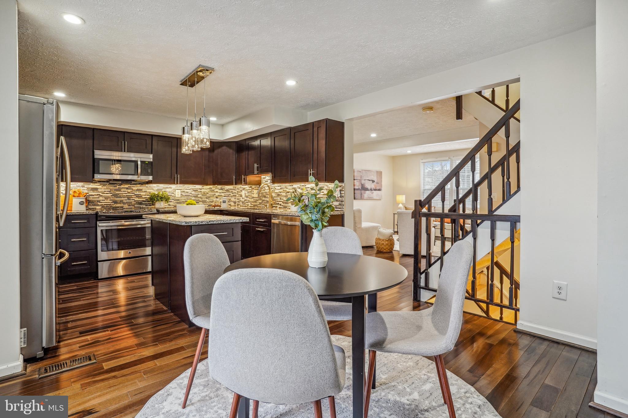 6377 Generals Court Centreville, VA 20121 - Photo 13 of 32 a outdoor kitchen with table and chairs