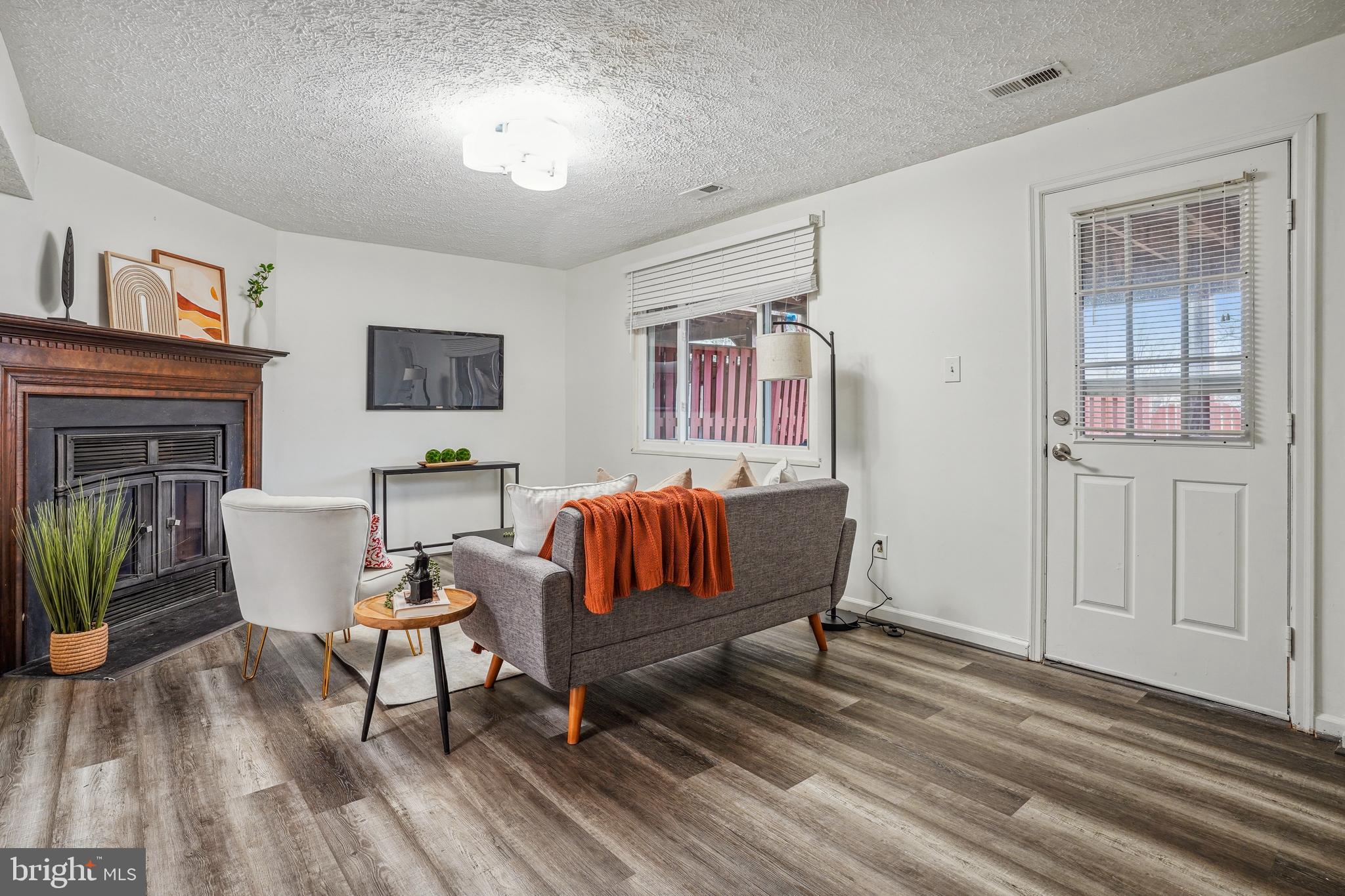 6377 Generals Court Centreville, VA 20121 - Photo 25 of 32 a living room with furniture and a wooden floor