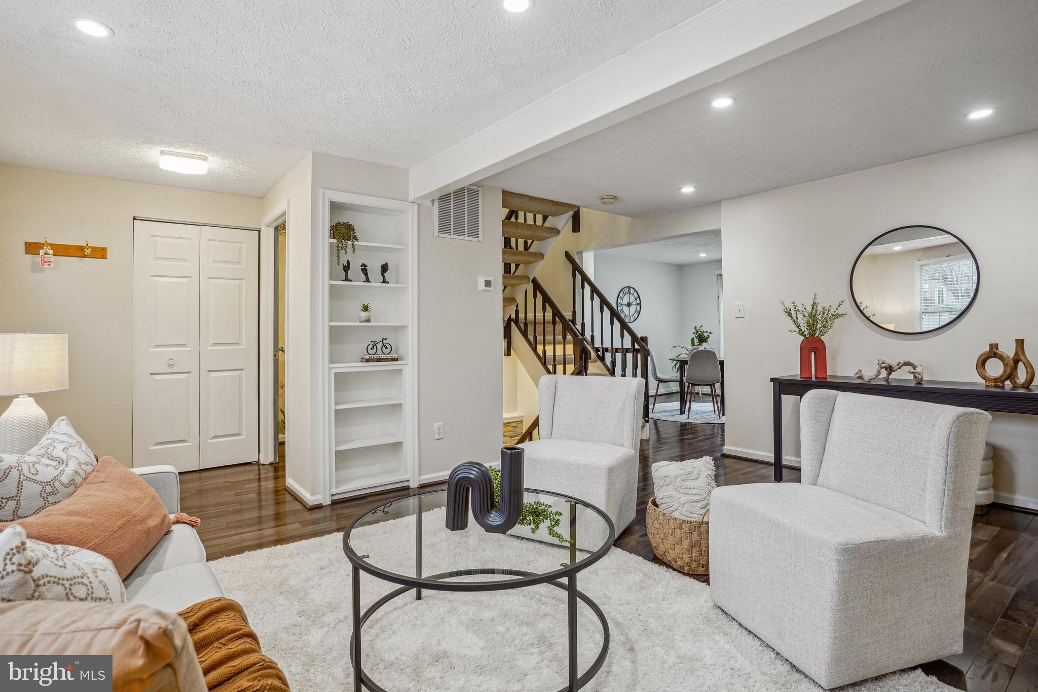 6377 Generals Court Centreville, VA 20121 - Photo 3 of 32 a living room with furniture a rug and white walls