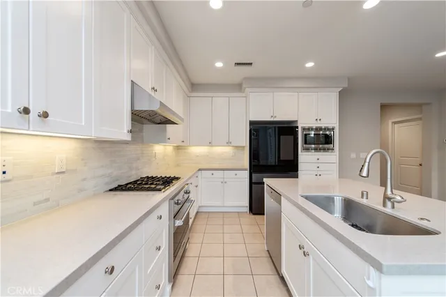 a view of a room with a large window and flower pot