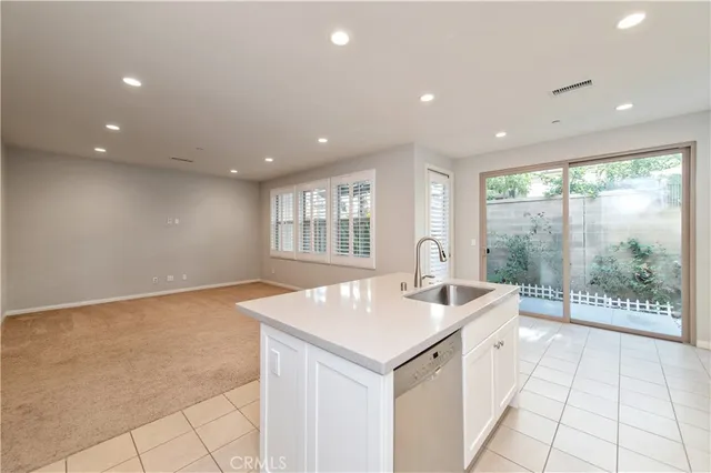 a kitchen with a sink window and cabinets