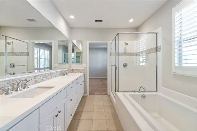 a spacious bathroom with a granite countertop sink mirror and double