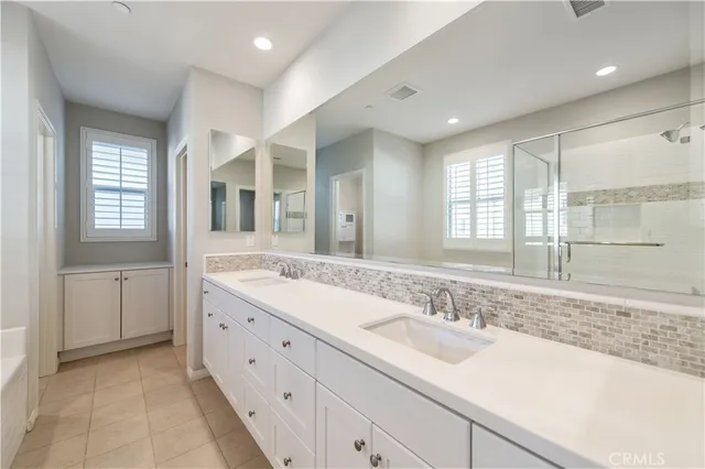 a spacious bathroom with a bathtub and a shower