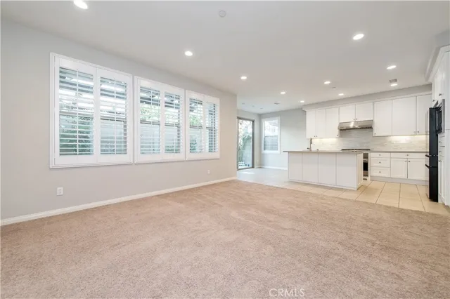 a view of a kitchen with a sink and a refrigerator