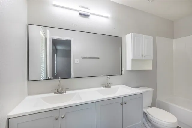 a bathroom with a sink toilet and vanity