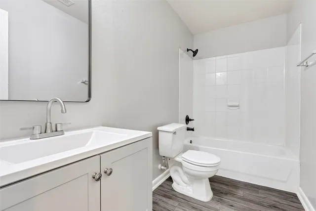 a bathroom with a sink toilet a mirror and shower