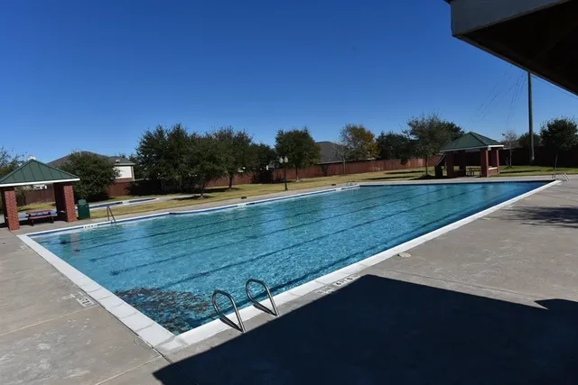 a view of a swimming pool with a yard