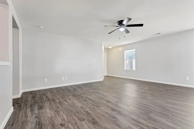 wooden floor in an empty room with a window