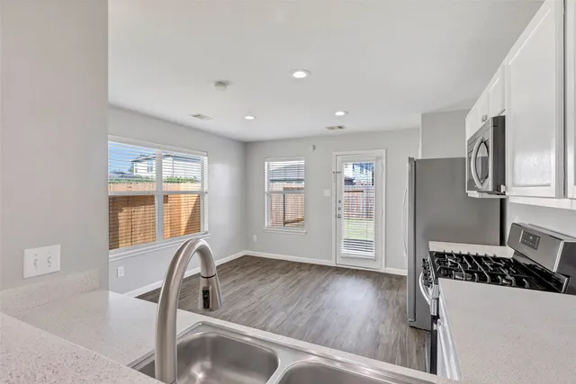 a view of a kitchen with a sink dishwasher and a refrigerator