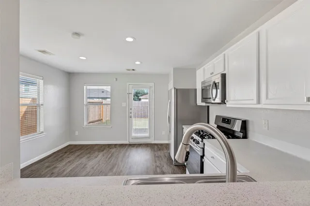 a view of a kitchen with sink and dishwasher
