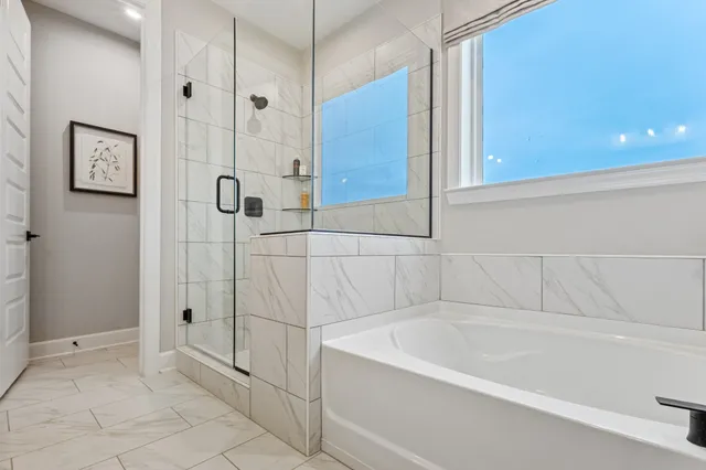 a bathroom with a bathtub and shower