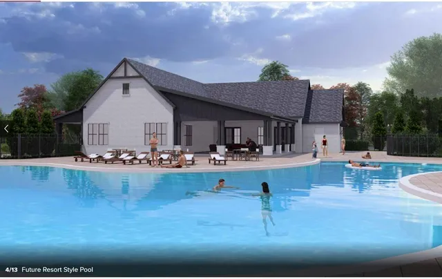 a view of swimming pool with outdoor seating and plants