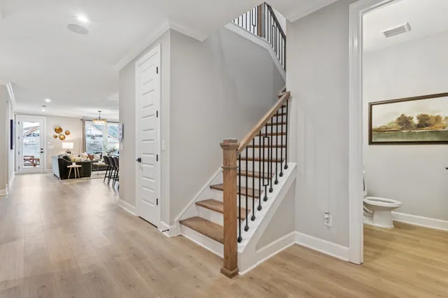 a view of a hallway with dining room and wooden floor