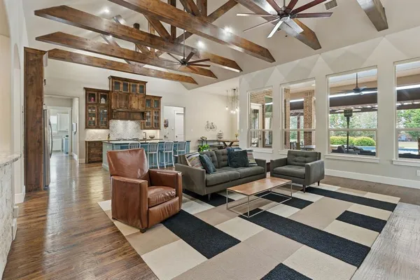 a living room with lots of furniture and a chandelier