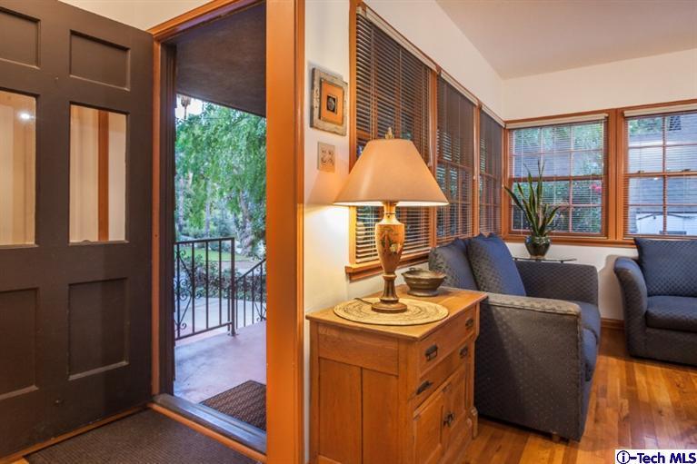 525 Lakeview Road Pasadena, CA 91105 - Photo 2 of 23 a living room with furniture a large window and a flat tv screen