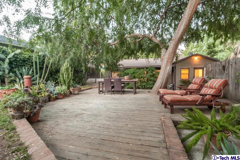 525 Lakeview Road Pasadena, CA 91105 - Photo 22 of 23 a view of a patio with chair and table and chairs under an umbrella