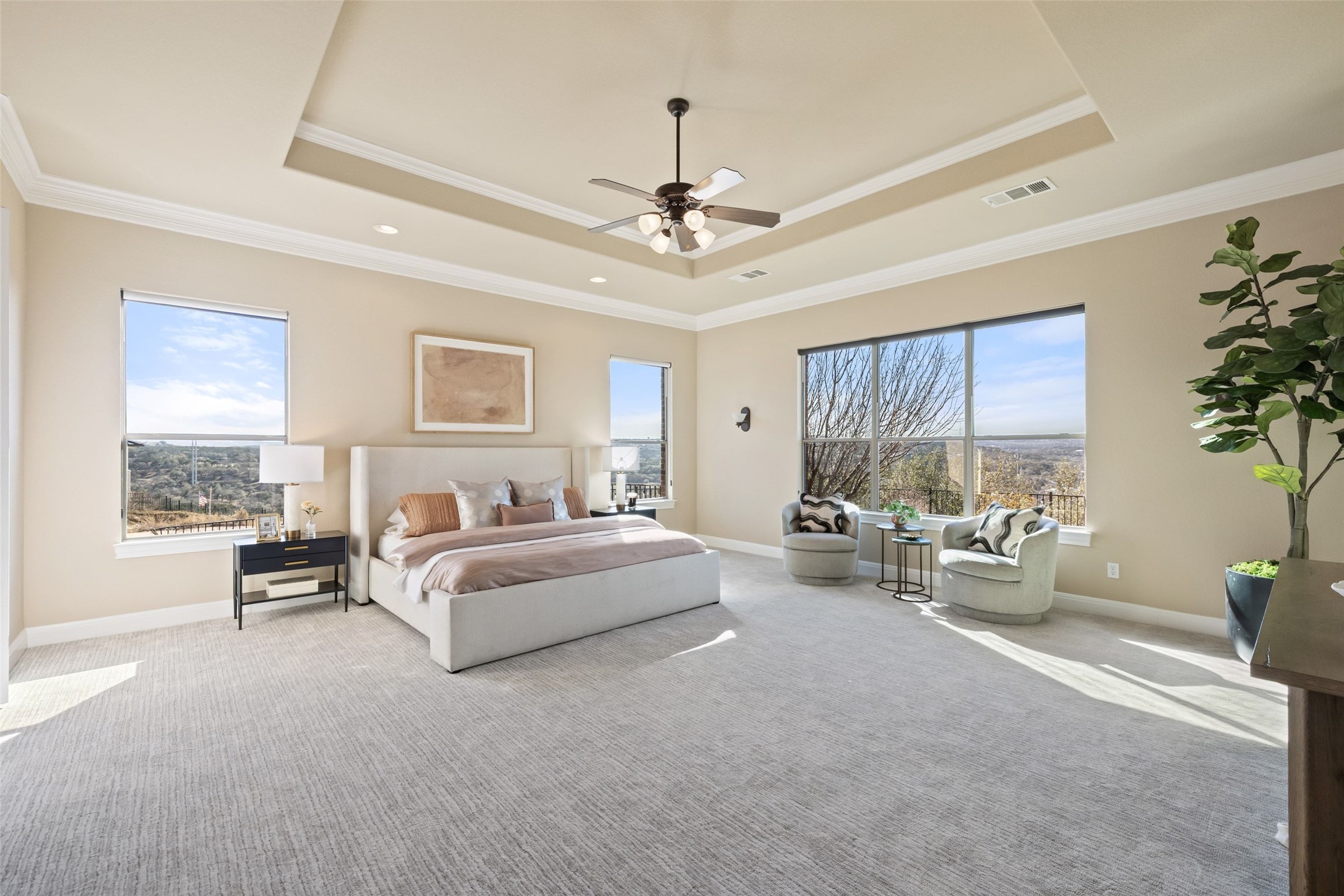 2702 Lakehurst Road Spicewood, TX 78669 - Photo 22 of 40 a spacious bedroom with bed and a chandelier