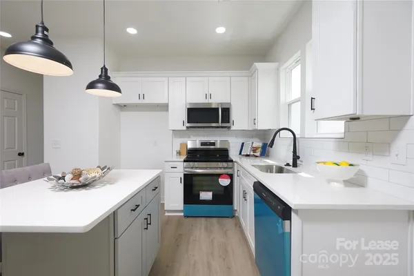 a kitchen with a sink stove and microwave
