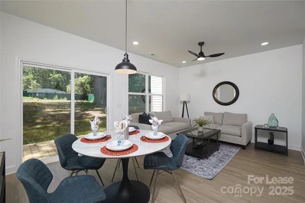 a living room with furniture a table and a large window