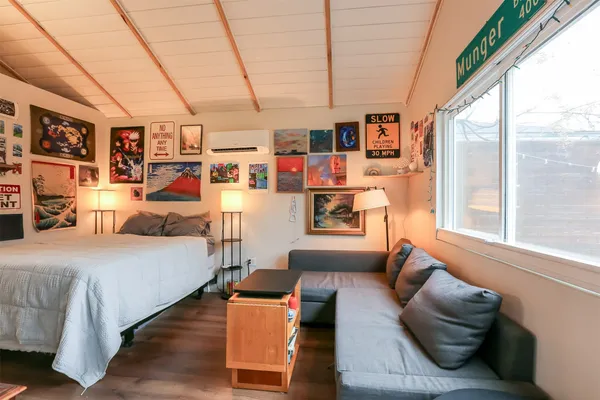 a bedroom with furniture and a large window