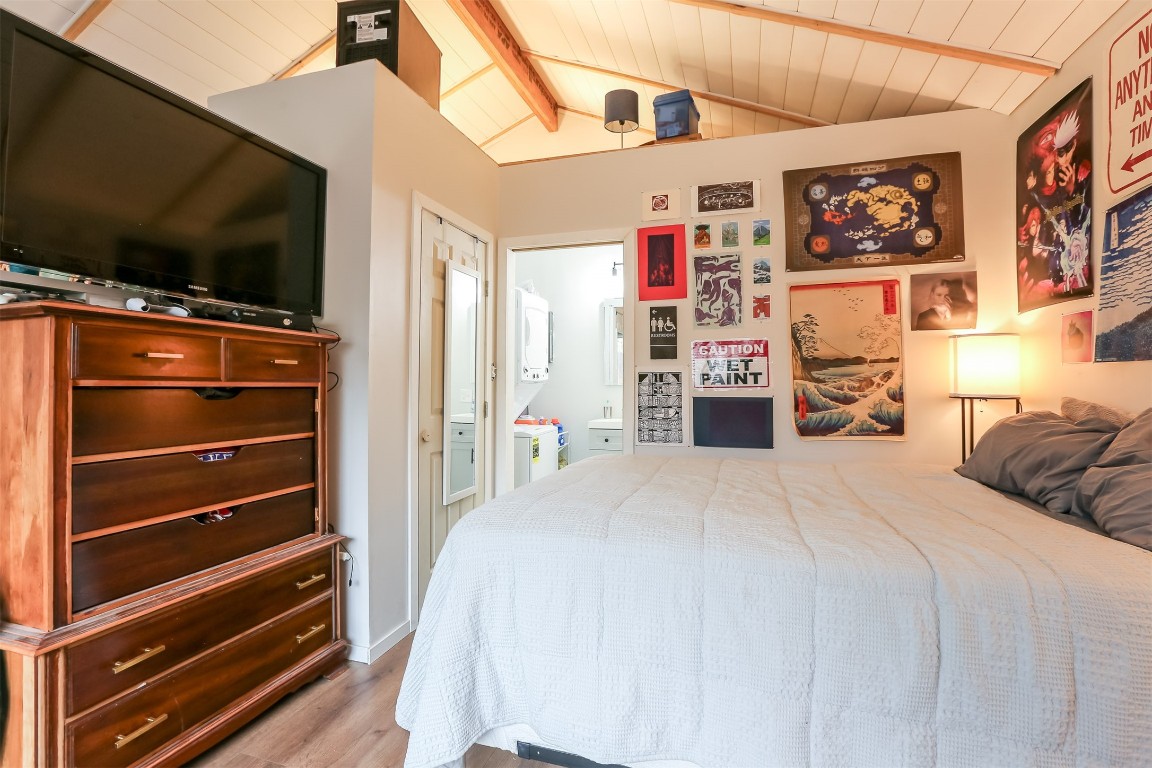 308 East 32nd Street, Unit B Austin, TX 78705 - Photo 18 of 27 a bedroom with a bed and a flat screen tv