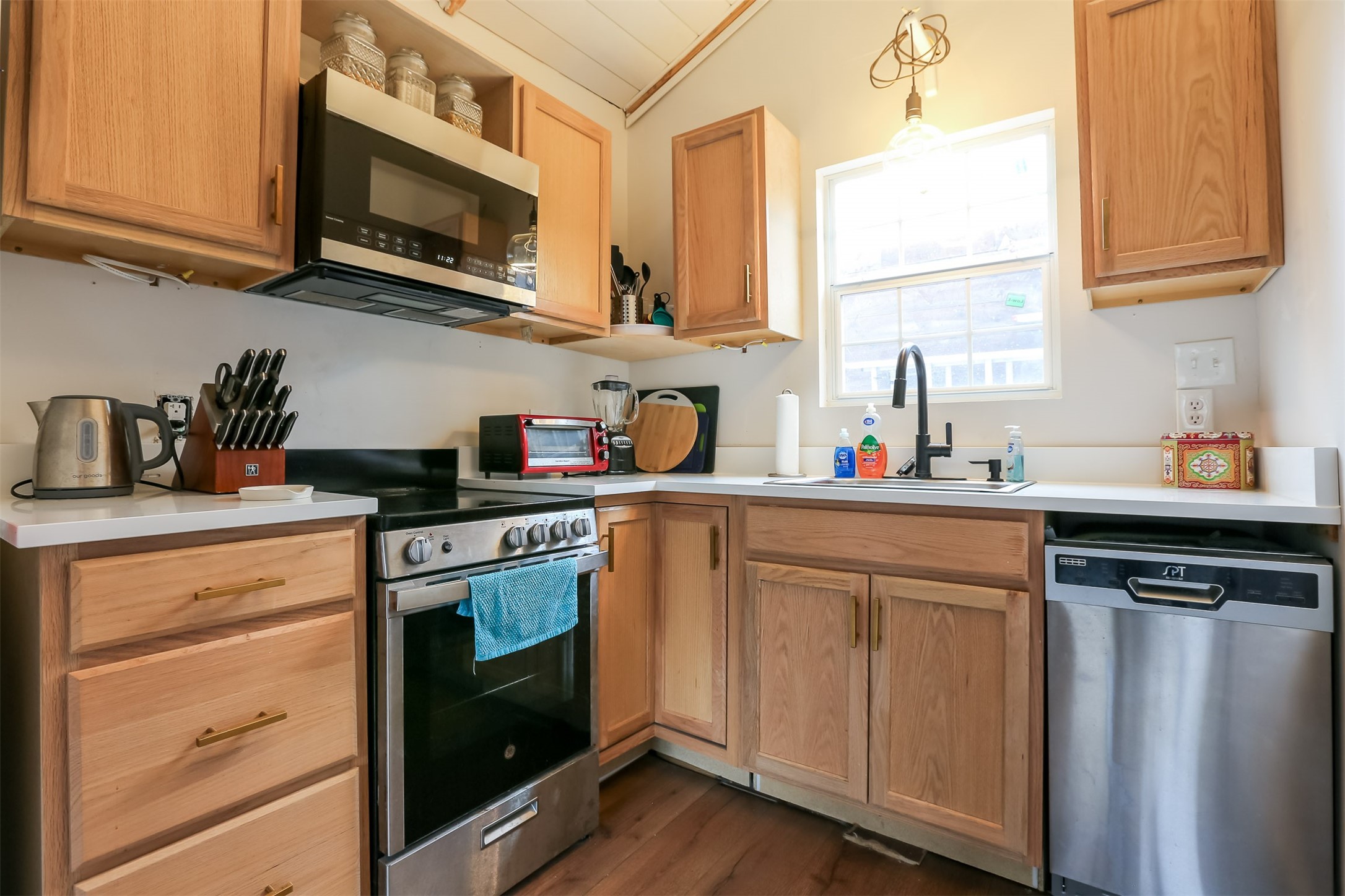 308 East 32nd Street, Unit B Austin, TX 78705 - Photo 2 of 27 a kitchen with stainless steel appliances granite countertop a sink a stove and cabinets