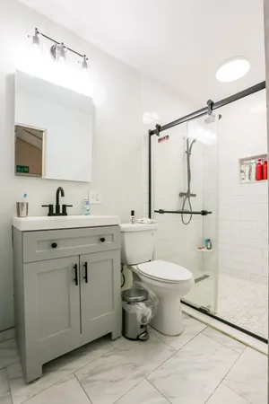 a bathroom with a sink toilet and shower