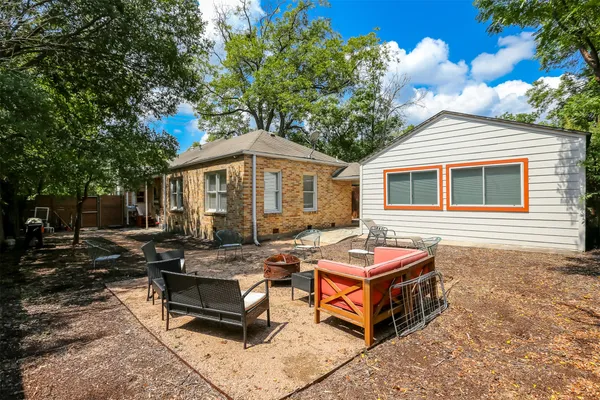 a backyard of a house with yard barbeque oven and outdoor seating