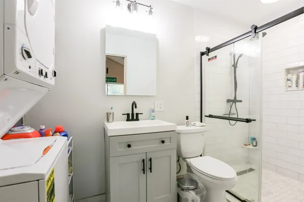 a bathroom with a sink toilet vanity and tub