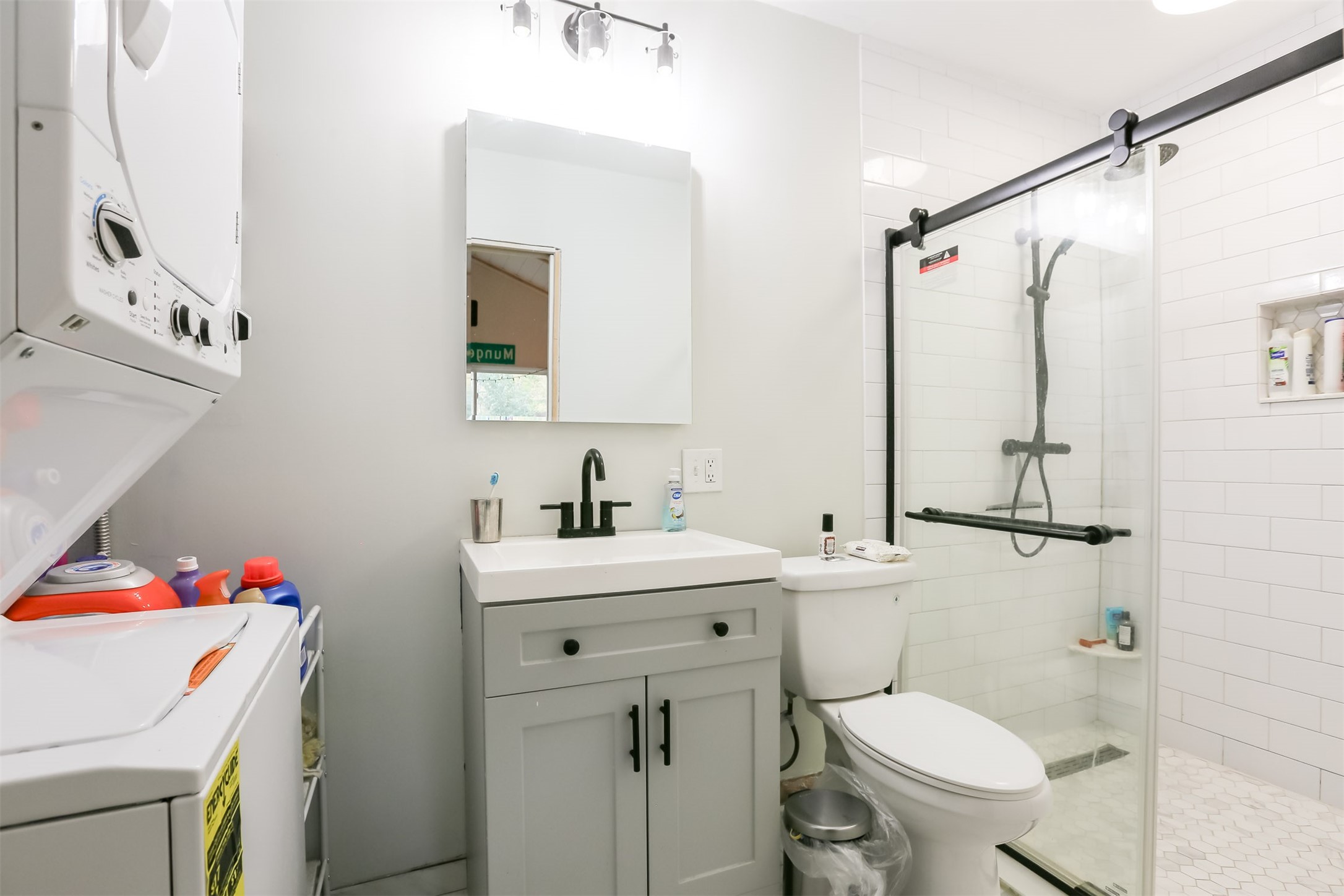 308 East 32nd Street, Unit B Austin, TX 78705 - Photo 4 of 27 a bathroom with a sink toilet vanity and tub