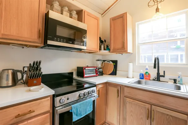 a kitchen with stainless steel appliances granite countertop a sink a stove and cabinets