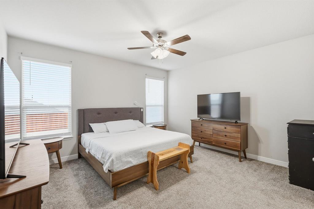 1420 Pleasanton Road Cleburne, TX 76033 - Photo 20 of 39 a bedroom with a bed and a flat screen tv