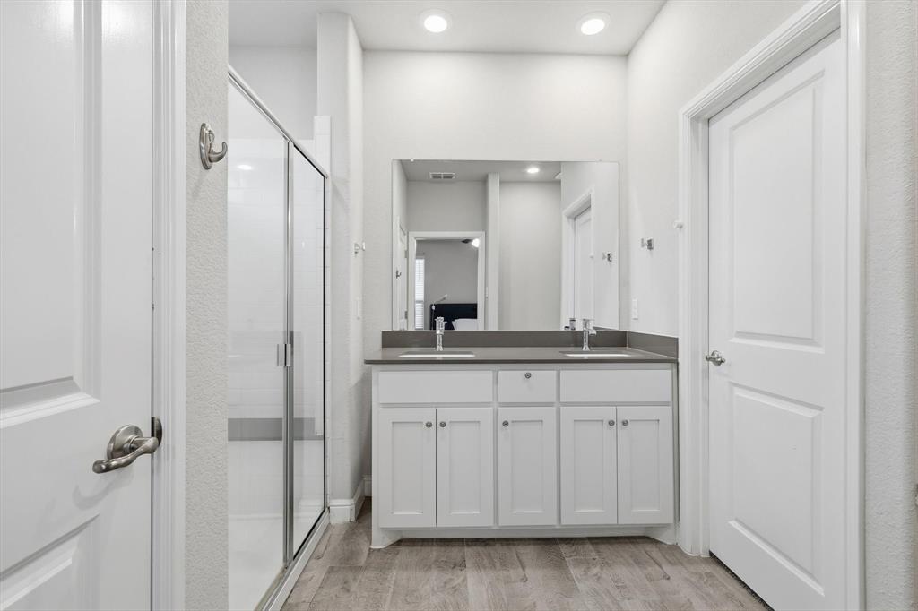 1420 Pleasanton Road Cleburne, TX 76033 - Photo 22 of 39 a bathroom with a double vanity sink and mirror
