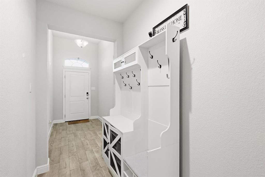 1420 Pleasanton Road Cleburne, TX 76033 - Photo 6 of 39 a view of a livingroom with wooden floor and white walls
