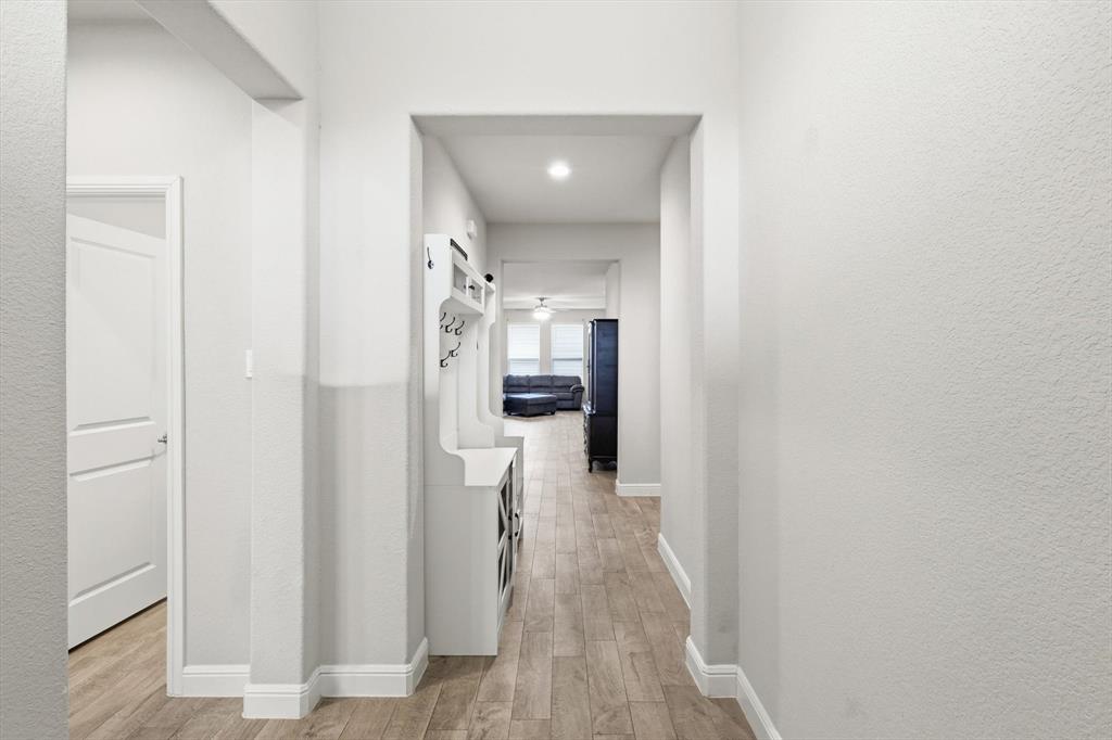 1420 Pleasanton Road Cleburne, TX 76033 - Photo 7 of 39 a view of a hallway with wooden floor