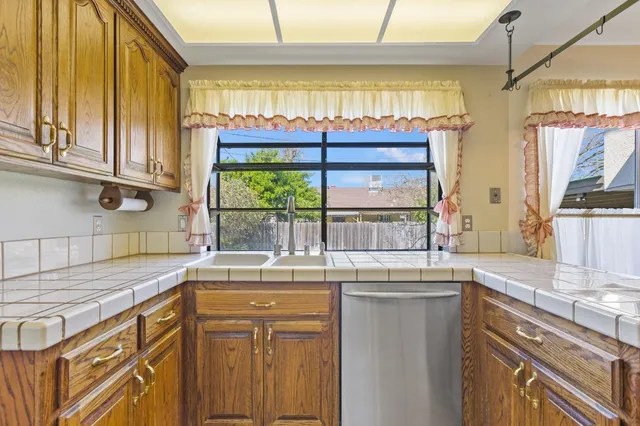 a kitchen with stainless steel appliances granite countertop a stove and a microwave