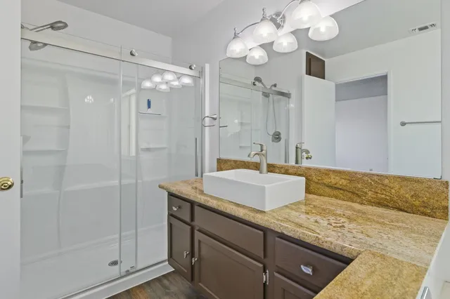 an empty room with a window and a painting on the wall