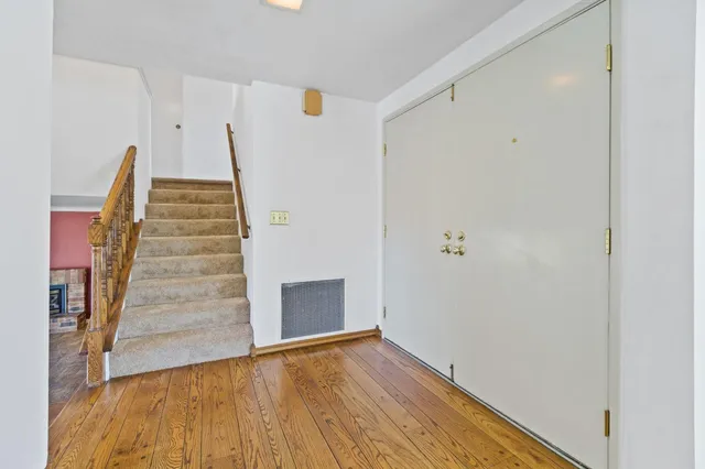 a view of a room with wooden floor and cabinet