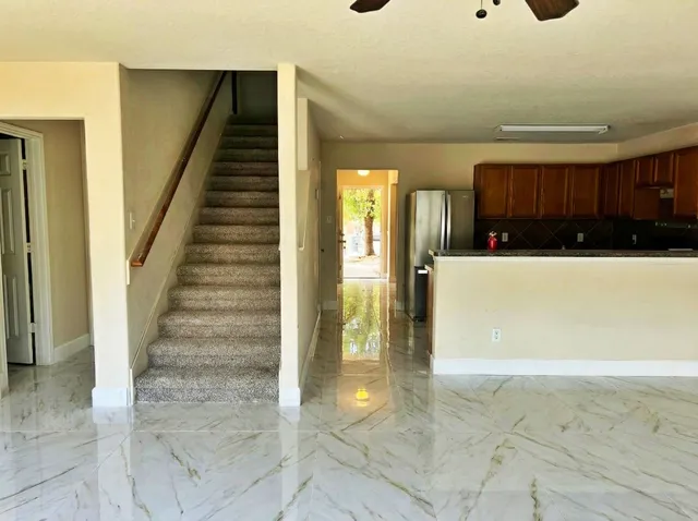 a view of a hallway with entryway and chandelier